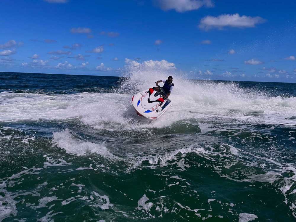 A man driving a jet ski in the sea